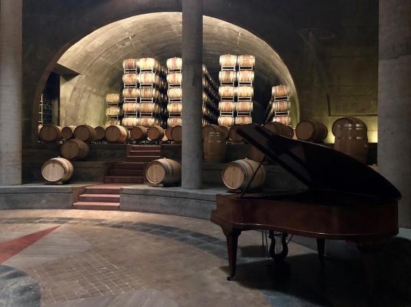 A grand piano in the wine cellar.