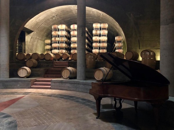 A grand piano in the wine cellar.